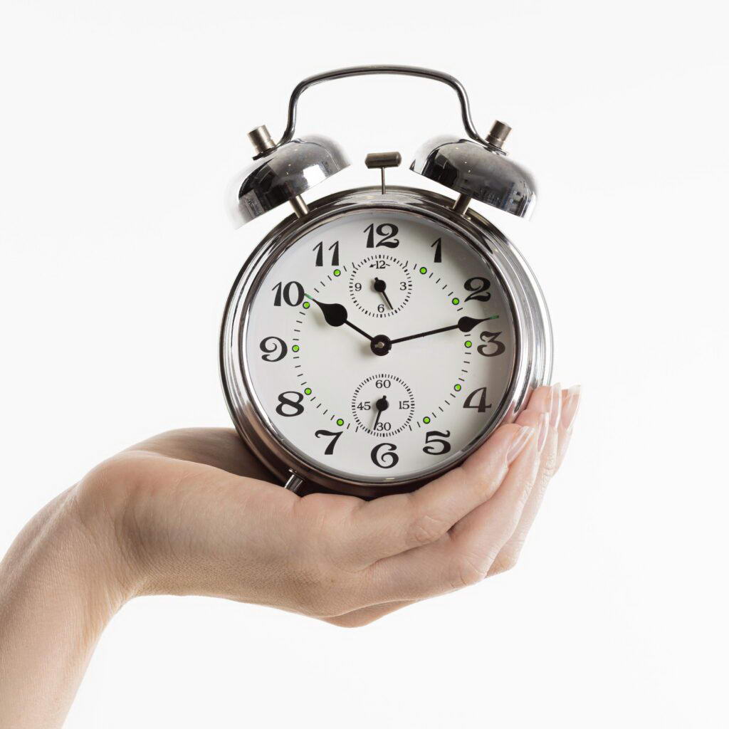 hand-holding-alarm-clock